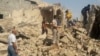 People walk through the rubble of a Shi'ite mosque after it was destroyed in a bomb attack by militants of the Islamic State in the city of Mosul on July 23.