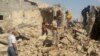 People walk through the rubble of a Shi'ite mosque after it was destroyed in a bomb attack by militants of the Islamic State, formerly known as the Islamic State in Iraq and the Levant (ISIL), in the Iraqi city of Mosul on July 23. 