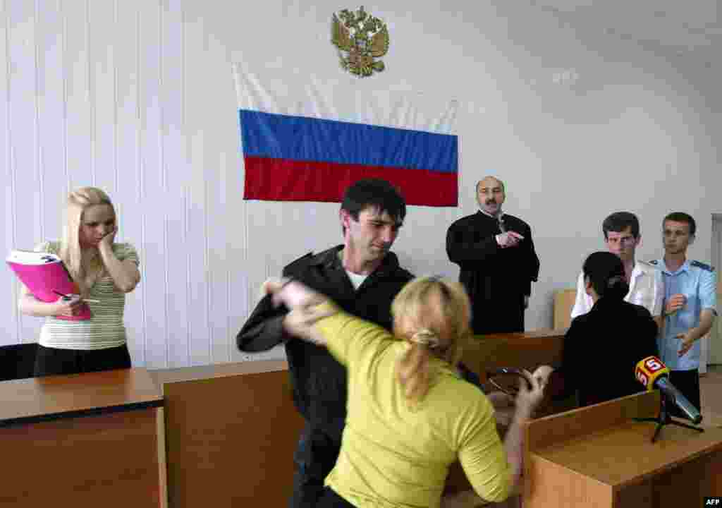Relatives of Beslan victims erupt in court after police officers convicted of negligence were pardoned in May (AFP) - "All this time, the victims have given investigators new statements," Maria Litvinovich, the editor of the "Truth About Beslan" website, tells RFE/RL's Russian Service. "But unfortunately, investigators paid no attention to these details. The investigation has made no progress whatsoever for the past six months, and it is not verifying the conclusions drawn by Yury Savelyev in his report."