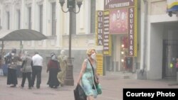 A woman in Moscow wears a protective mask in the thick smog.