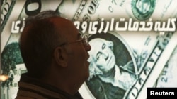 A man walks past a currency-exchange shop in northern Tehran last week.