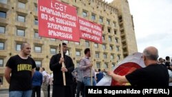 Georgian police detained at least eight people after conservative activists faced off against gay and lesbian protesters in Tbilisi on June 14.