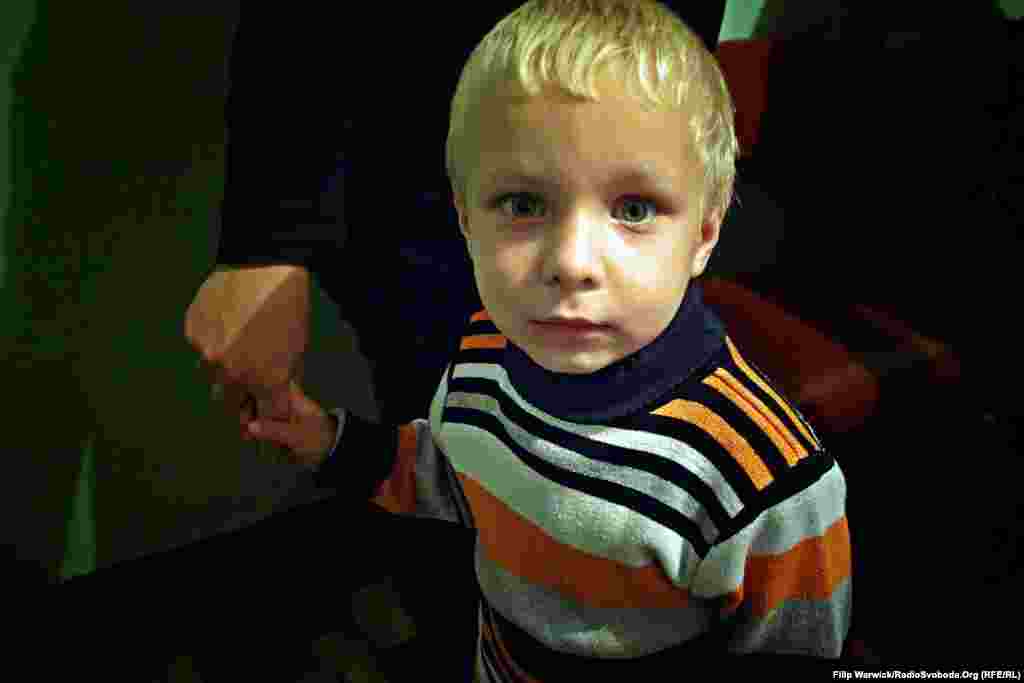 After fleeing their home, this child and his family now live in a student dormitory. Schooling can be a problem, however, because only children who have a certificate of education are permitted to attend classes. Many families were unable to bring the certificates with them as they were evacuated from their homes. 