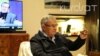 Iraqi President Jalal Talabani gestures as he sits in a rehabilitation facility in Berlin, December 9, 2013