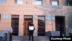 Руководитель Акмолинского областного филиала оппозиционной партии «Алга» Марат Жанузаков проводит акцию протеста у входа в Акмолинский областной департамент КНБ. Кокшетау, 30 января 2012 года. 
