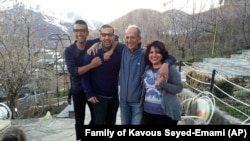 A photo provided by the family of the late Iranian-Canadian professor Kavous Seyed-Emami, shows him (2nd R), his wife, Maryam Mombeini (R) and their two sons at an unidentified place in Iran, undated