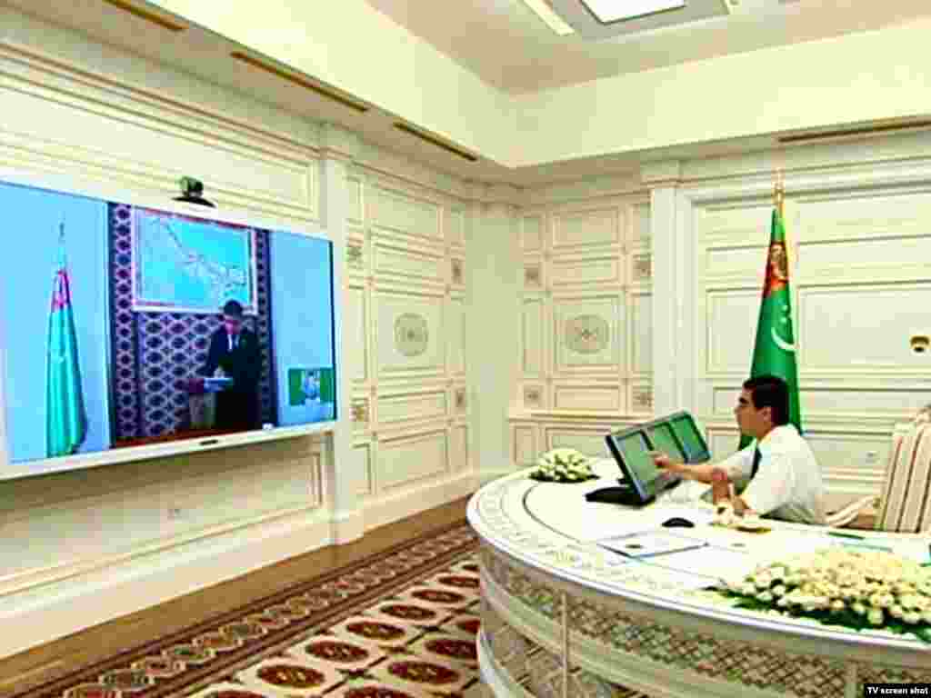 Berdymukhammedov participating in a government video conference from his presidential office. Even the traditional Turkmen carpet, usually woven in a range of reds, has been adapted to reflect the president's predilection for white.