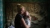 A mother and child who have fled from fighting in Slovyansk stand in their temporary accommodation in the eastern town of Nyzhnya Krynka on June 4.
