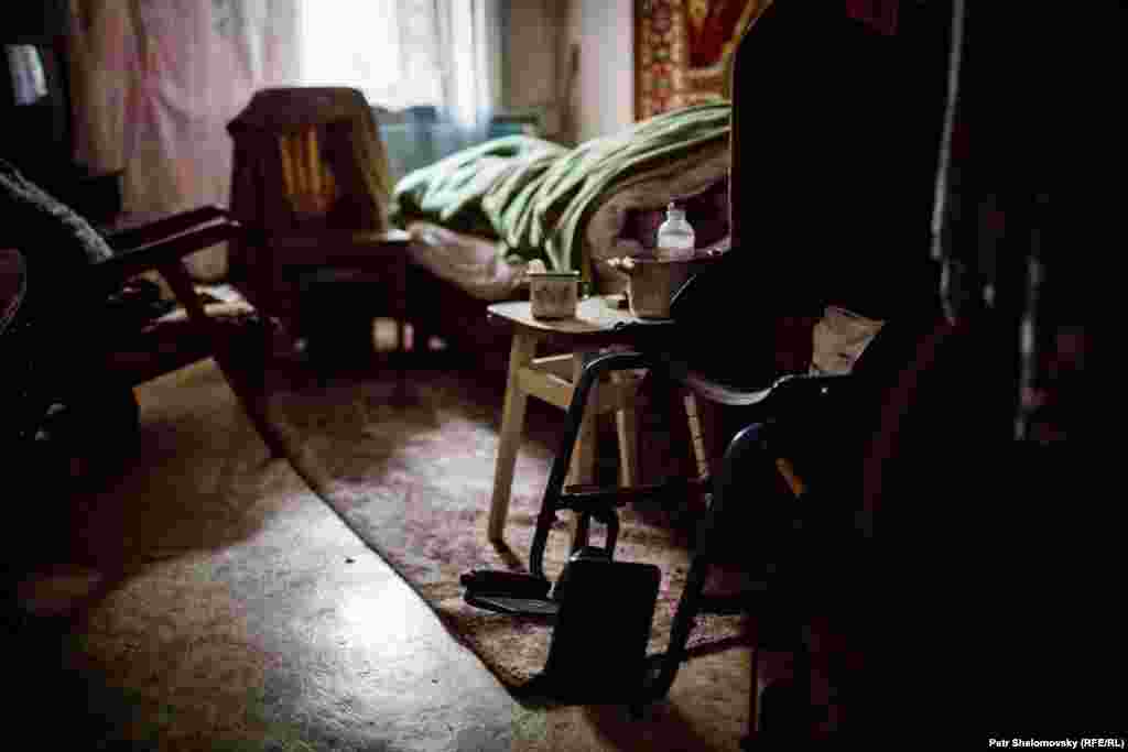 Maria, 81, lies in bed at her home. She cannot walk and is unable to leave the town, in spite of government efforts to help civilians flee.