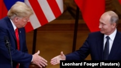 U.S. President Donald Trump (left) and Russian President Vladimir Putin shake hands as they hold a joint news conference after their meeting in Helsinki on July 16.