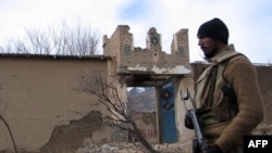 FILE: A Pakistani soldier stands beside a an alleged Taliban training center in Makeen, South Waziristan.