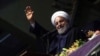 Iranian President Hassan Rohani greets supporters during a campaign rally in Hamedan on May 8.