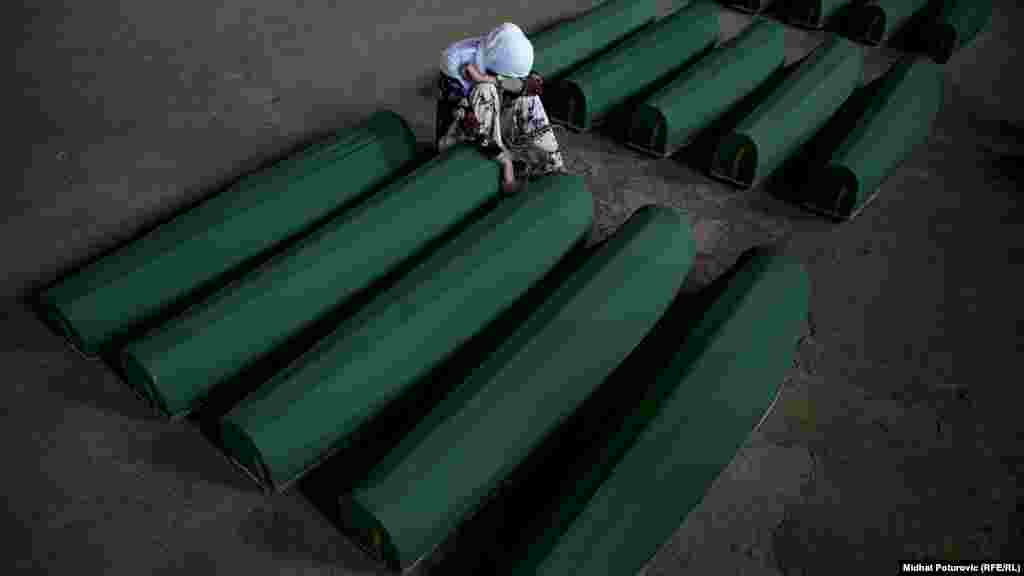 A woman cries over the coffin of a victim of the&nbsp;1995 Srebrenica massacre in Bosnia-Herzegovina on July 10 as 35 newly identified victims were reburied at the Potocari Memorial Center. Bosnian Serb forces who overran the town of Srebrenica in July 1995 killed some 8,000 Muslim men and boys. (Midhat Poturovic, RFE/RL)