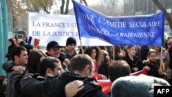 Armenians rally outside the French Embassy in Yerevan to thank France for a bill passed by its Senate making denial of the Armenian genocide a crime on January 24.