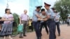 Kazakhstan - Law enforcement officers detain a man during a protest rally held by Kazakh opposition supporters in Almaty, Kazakhstan July 6, 2019. REUTERS/Pavel Mikheyev