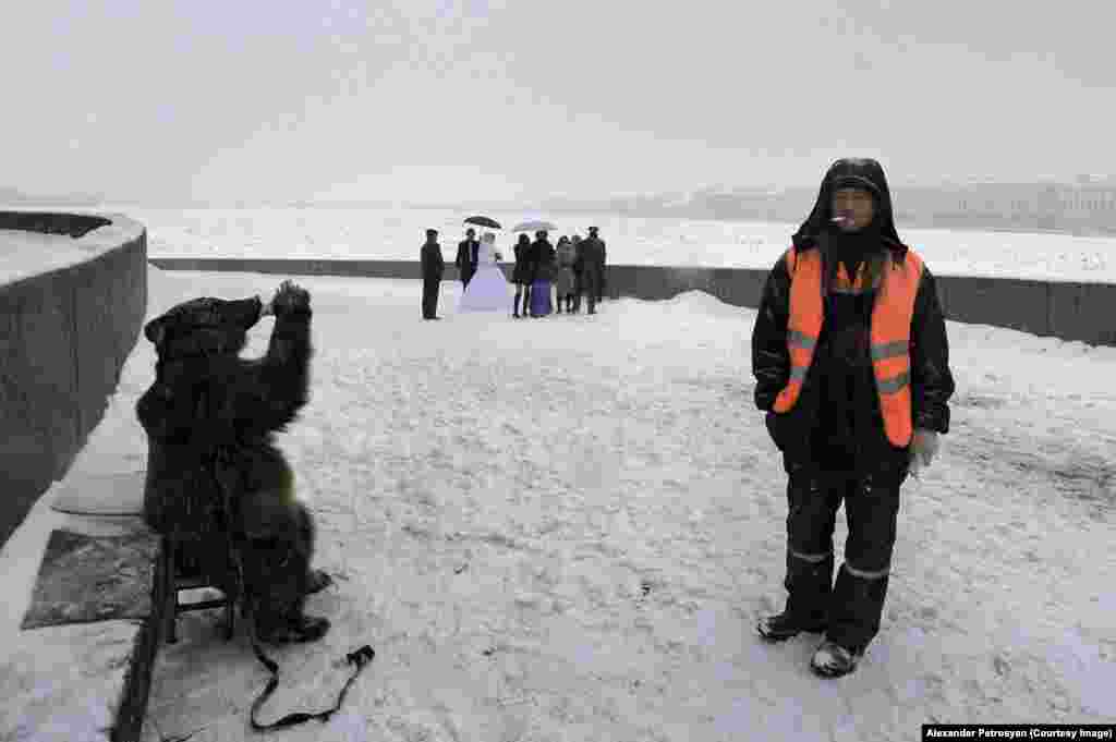 Vasilevsky Island, in the center of the River Neva, is where the newlyweds come to have their pictures taken. You can pay to release a dove, maybe pose atop a white horse. When Petrosyan visited, he found this scene. He told RFE/RL: &quot;There weren&#39;t enough weddings that day and the bear wasn&#39;t in demand. To somehow sweeten its bitter fate, the owner gave the bear a drink.&quot;