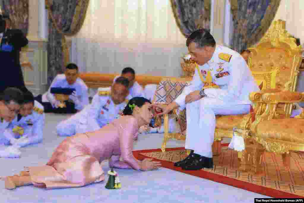 Thailand&#39;s King Maha Vajiralongkorn (right) and Queen Suthida during their wedding ceremony in Bangkok. Thailand announced on May 1 that King Maha Vajiralongkorn&#39;s longtime consort had become his fourth wife, bestowed with the title Queen Suthida -- a surprise move just days before his coronation. (AFP/Thai Royal Household Bureau)