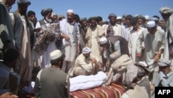 Members of the community attend a funeral after a NATO air strike that destroyed two fuel tankers hijacked by the Taliban in northern Konduz Province.