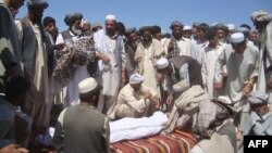 Members of the community attend a funeral after a NATO air strike that destroyed two fuel tankers hijacked by the Taliban in northern Konduz Province.