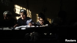 Pakistan -- Students read the Koran at the Jamia Binoria Al-Alamia Seminary Islamic Study School in Karachi, 10Dec2012