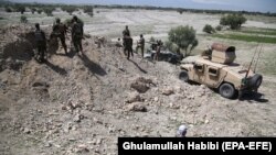 Afghan security officials patrol during an operation against suspected militants in the Chaparhar district of Nangarhar Province.