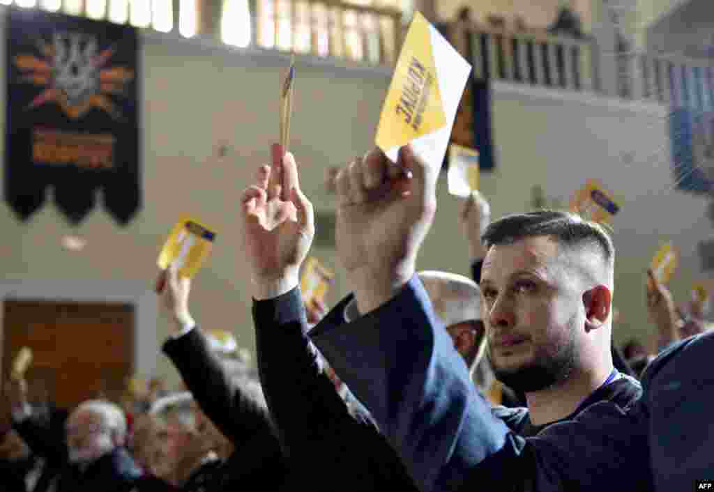 Members of Ukraine’s far-right Azov battalion move to officially create a political party in Kyiv on October 14. (AFP/Genya Savilov)