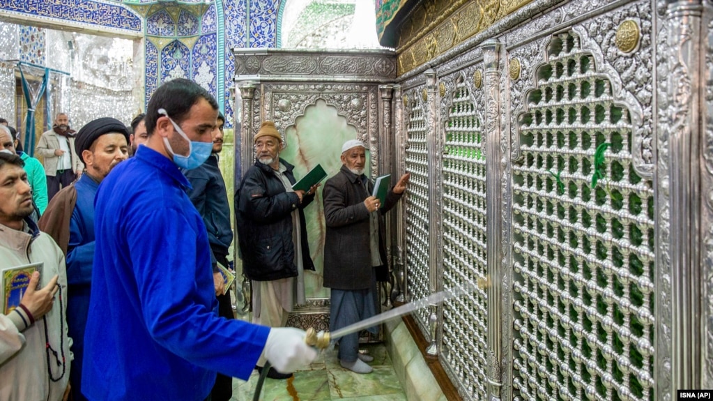 A man disinfects the shrine of Saint Masoumeh against coronavirus in the city of Qom, February 25, 2020