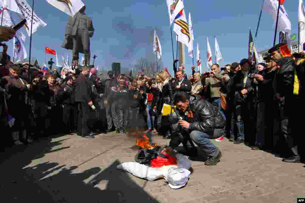 During the rally in Donetsk, a pro-Russia supporter burns an effigy of Stepan Bandera (1909 &ndash;1959), one of the leaders of the national movement which fought for Ukrainian independence in the mid-20th century.