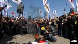 A pro-Russian protester burns an effigy of Stepan Bandera, the leader of Ukrainian nationalist resistance during World War II, during a rally in the eastern Ukrainian city of Donetsk on April 6.