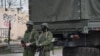 Armed men who are believed to be Russian troops on the streets of Simferopol.