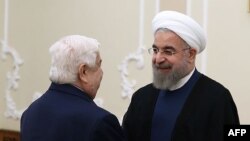 Хасан Роухани во время встречи с министром иностранных дел Сирии Валидом аль-Муаллемом в Тегеране, 5 августа 2015 года.