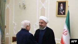 Хасан Роухани во время встречи с министром иностранных дел Сирии Валидом аль-Муаллемом в Тегеране, 5 августа 2015 года.