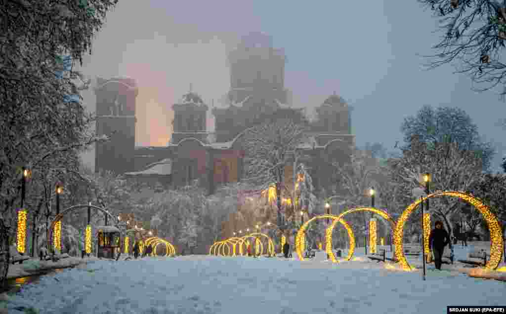 A man passes by Christmas lights in Belgrade. (epa-EFE/Srdjan Suki)