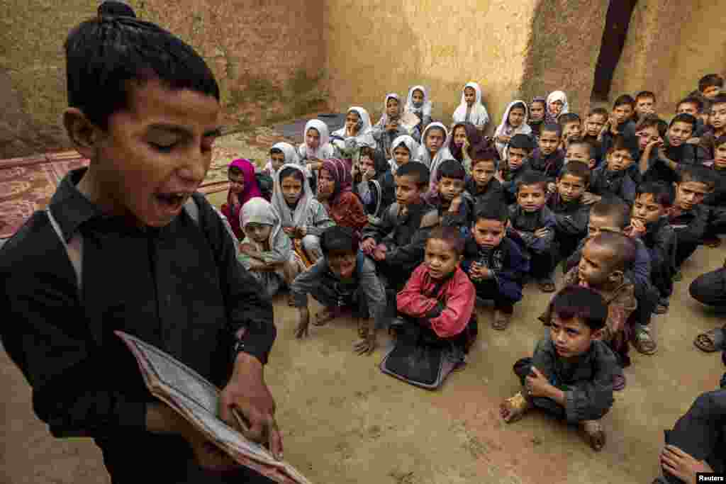 A Pakistani boy recites from a book during a lesson at a school in a slum on the outskirts of Islamabad. (Reuters/Zohra Bensemra)