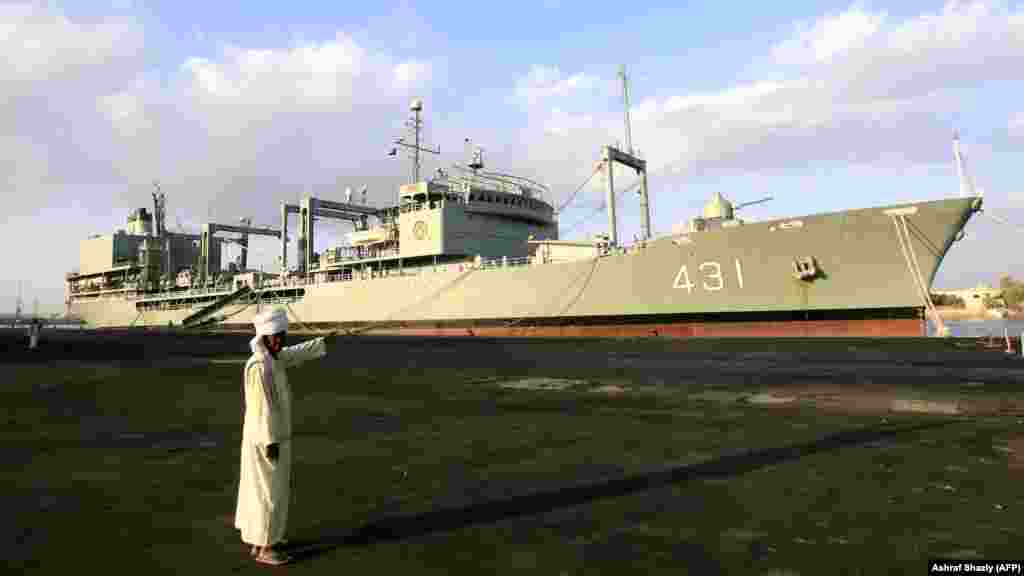 A Sudanese man points at the Iranian replenishment ship &quot;Kharg&quot; docked in the Red Sea town of Port Sudan on October 31. The visit of two Iranian naval ships to Sudan reflected strong ties between the countries. (AFP/Ashraf Shazly)