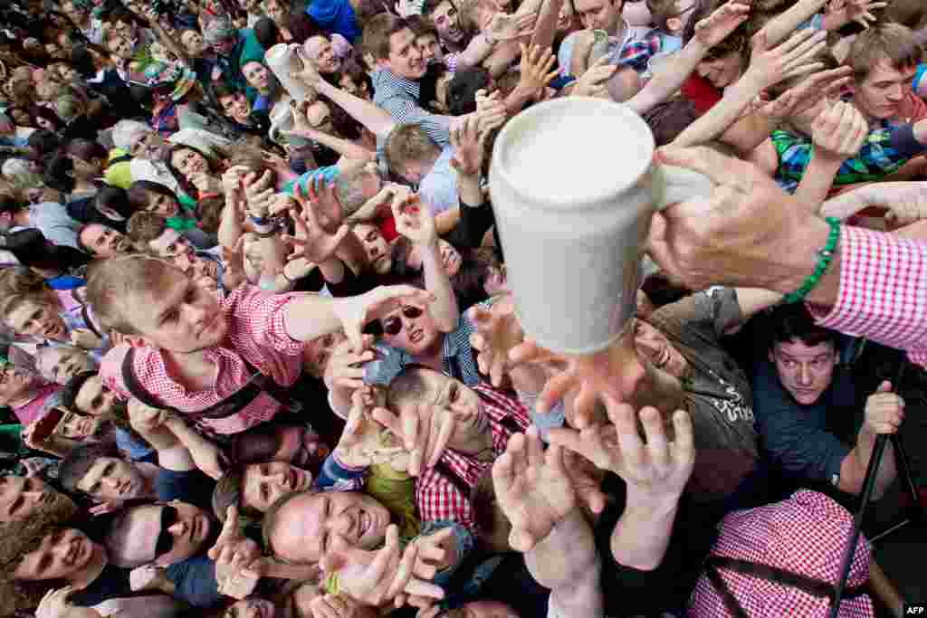 Visitors wait to receive the first beer in Erlangen, Bavaria, during the opening ceremony called Anstich of the traditional beer festival Bergkirchweih. The event is one of the biggest open-air beer gardens in Europe. (AFP/Daniel Karmann)