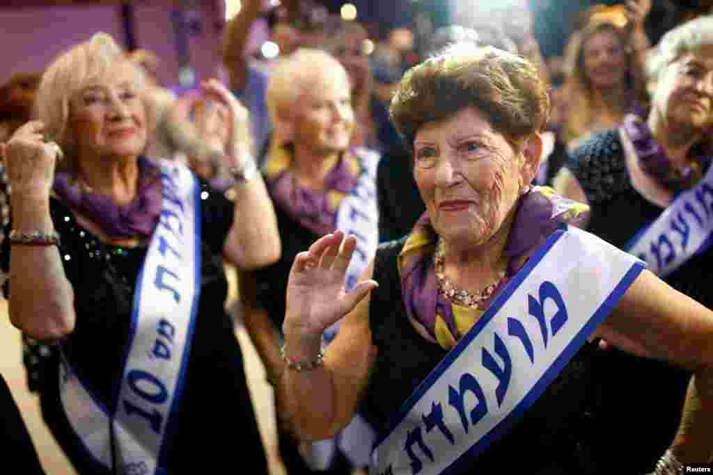 Holocaust survivor Carmela Ben Yehuda, 89, dances during the annual Holocaust survivors' beauty pageant in the Israeli city of Haifa. (Reuters/Amir Cohen)