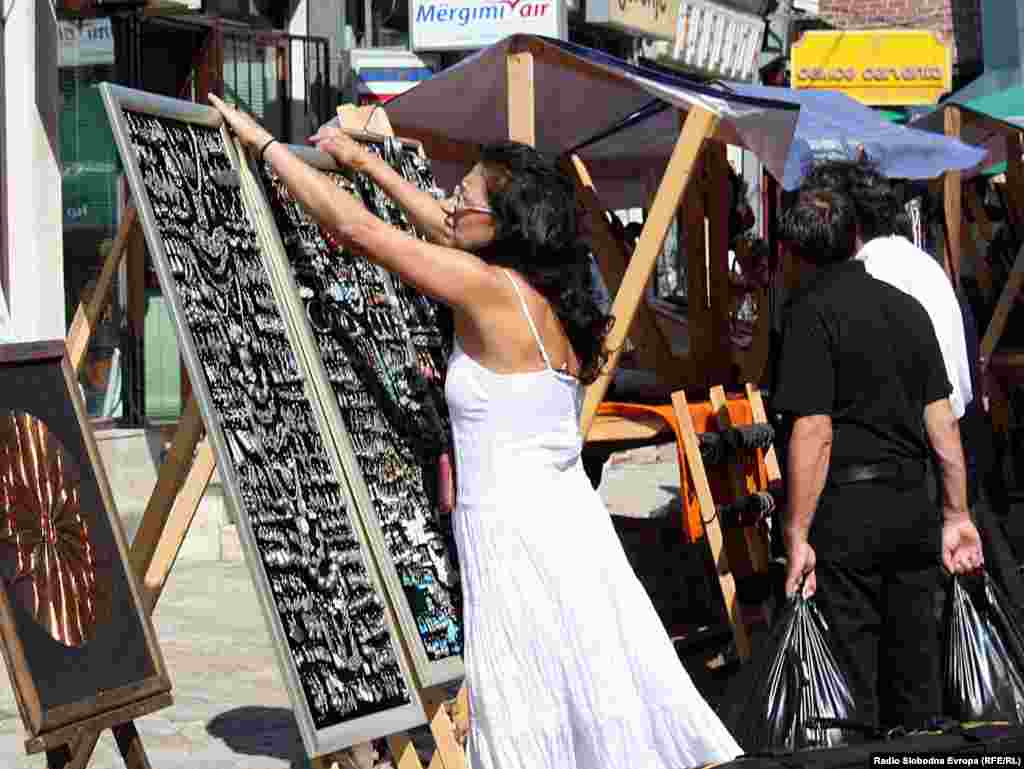 Жена ја поставува тезгата на пазарот за ракотворби во старата чаршија во Скопје
