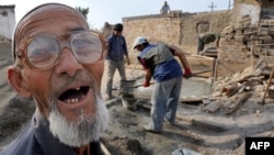 An ethnic Uzbek spoke as members of his family reconstructed their destroyed house in the village of Shark, outside Osh, soon after the ethnic violence in 2010.