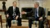 U.S. President George W. Bush (right) extends his hand to Britain Prime Minister Tony Blair in the Oval Office of the White House in Washington in 2006.