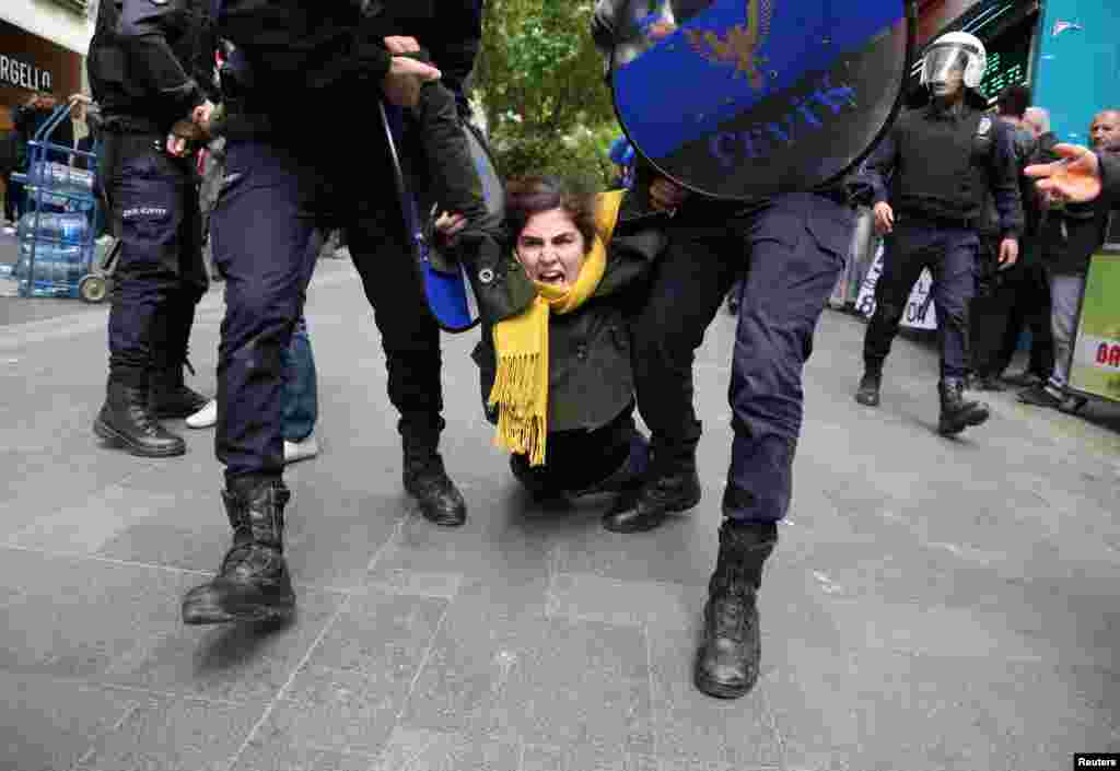 Riot police detain a demonstrator during a protest against the detention of two hunger-striking teachers in Ankara, Turkey. (Reuters)