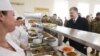 Ukrainian President Petro Poroshenko (right) queues for food with soldiers in the mess hall during his visit to the 95th Airborne Brigade in Zhytomyr on March 11.