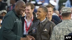 Ex-NBA great Magic Johnson (left) with U.S. President Barack Obama in November 2011