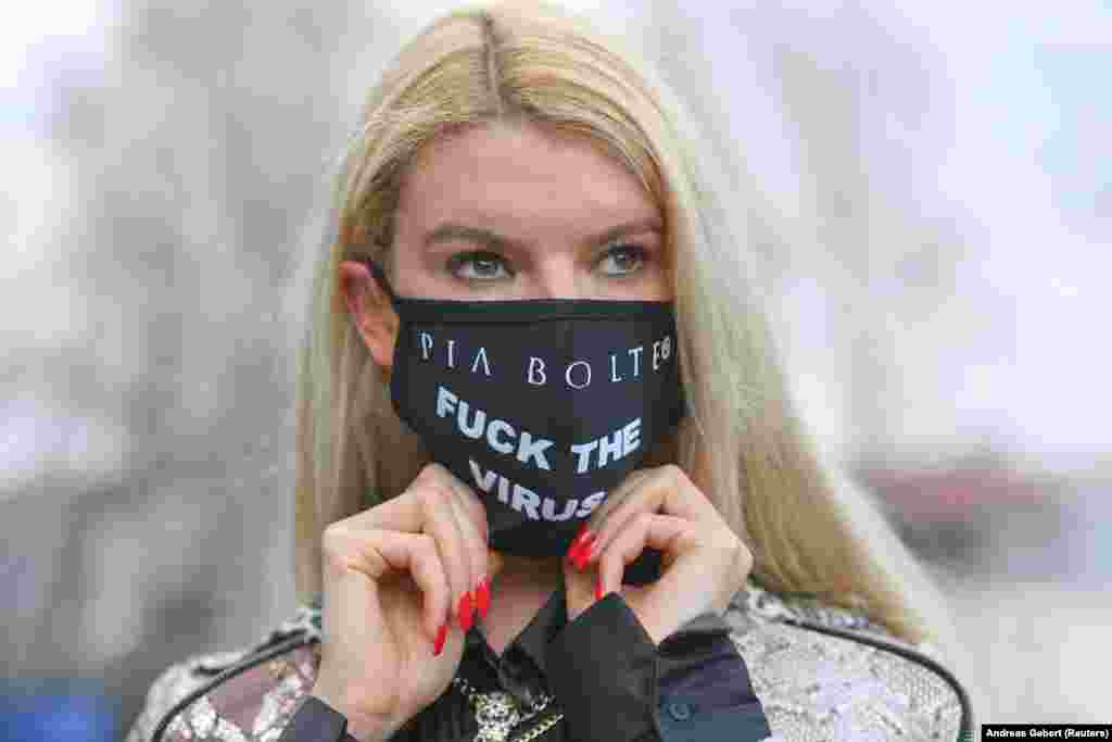 German fashion model Franziska wears a mask with a message that was tailored at the Pia Bolte Style shop in Munich.