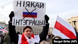 A protester holds a banner reading "No to integration!" during a rally in downtown Minsk on December 7.