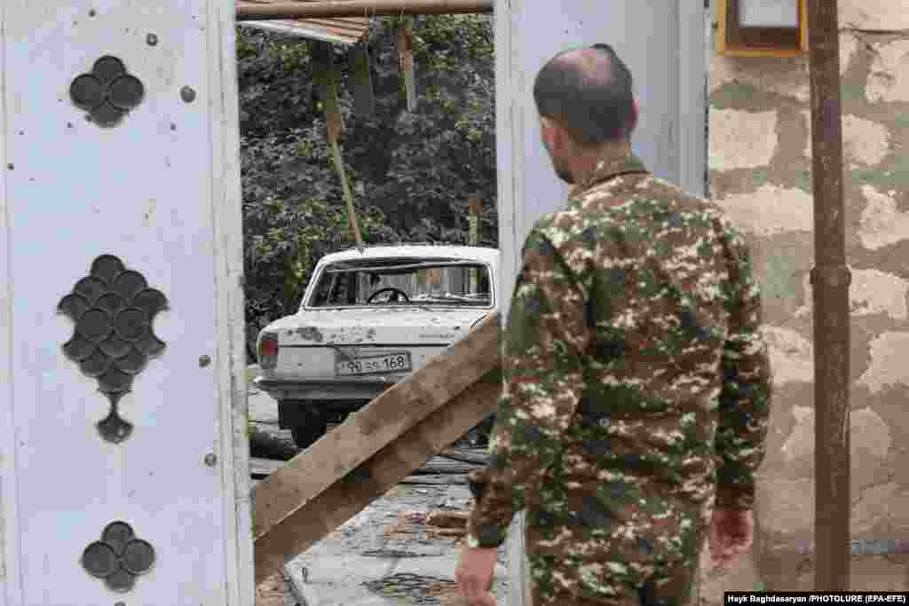 A man looks at damage allegedly caused by Azerbaijani shelling in the city of Martuni in the self-proclaimed Nagorno-Karabakh Republic.