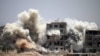 Smoke rises around buildings following a reported air strike on a rebel-held area in the southern Syrian city of Daraa, on June 22, 2017