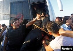 Un polițist protejează soldați puciști de mulțimea furioasă, Istanbul, 16 iulie 2016