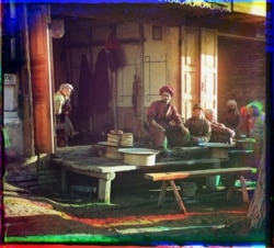 A man pauses a moment from grilling meat over hot coals at a restaurant in Samarkand.