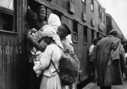 Refugees board a double-decker train carriage to escape the fighting in 1919. Most of the millions of casualties of the war were civilians.